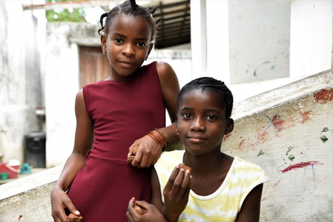 Elina (11), left, and her best friend Faria (12), right, near their homes in Cabo Delgado region in northern Mozambique. Elina’s house was badly damaged and Faria’s house was completely destroyed when Cyclone Kenneth hit her village in April 2019.