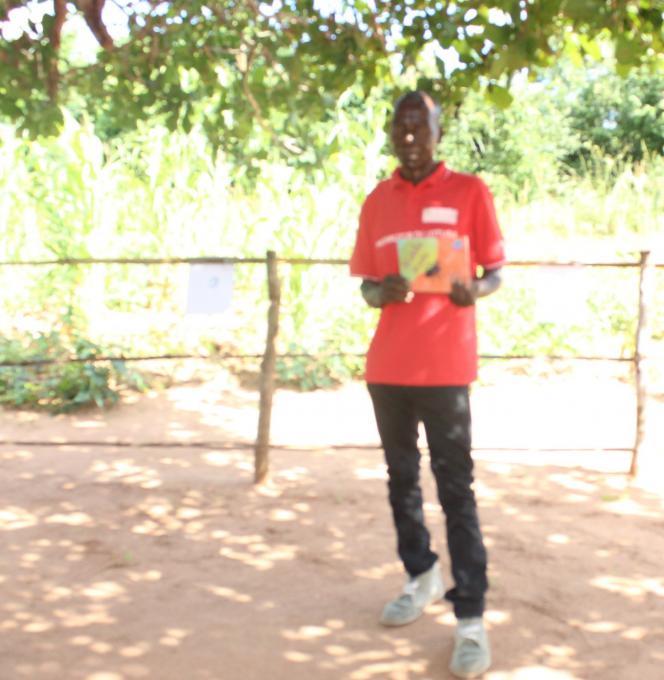 Damiao Augosto Viagem, a father of 2 children attending Community Reading Camp sessions  