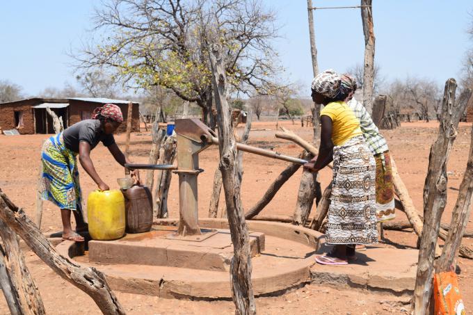 Women fetching water from a rehabilitated borehole in Tsokati Village